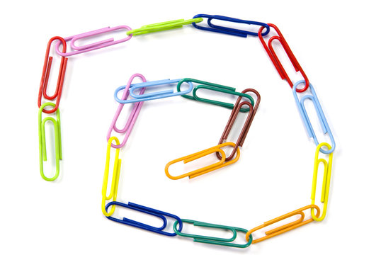 Color paper clips connected in chain, isolated on white.