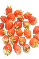 many strawberries over white