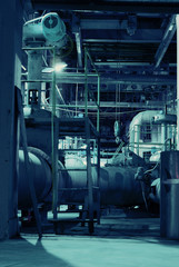 Equipment, cables and piping as found inside of a modern industr