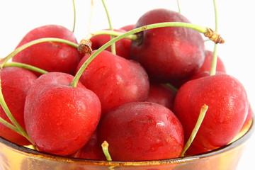 A plate with cherries on white background