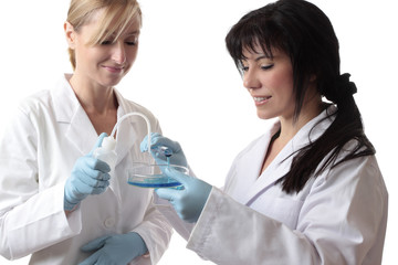 Fototapeta premium Scientists with test tube, bottle and petri dish