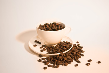 ceramic cup with coffee beans