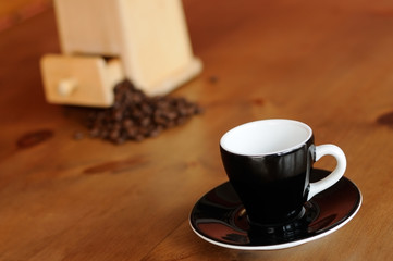 Espresso cup and saucer; grinder and coffee beans