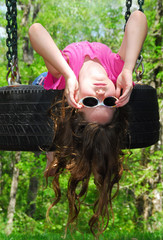 Young Girl Playing on Tire Swing © Cheryl Casey