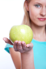 The girl with a green apple on a white background