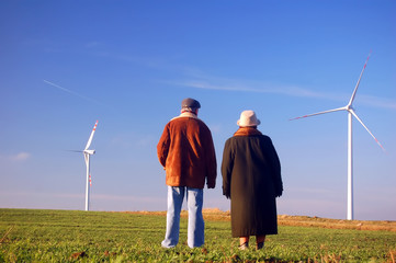 Seniors' couple and wind turbines