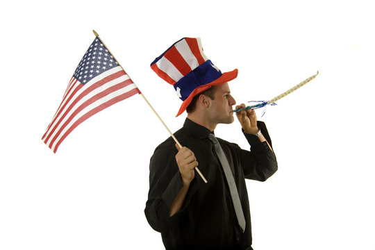 Young man wearing 4th of July hat and holding American flag