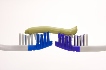 colored toothbrushes and green paste