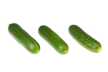 Three cucumbers on white.