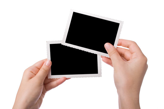 Hands holding a photograph isolated on a white background