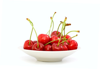 Saucer filled with red cherries