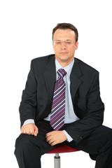 businessman in glasses sits on chair