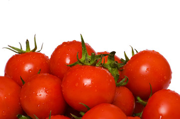 Wet whole tomatos arranged isolated on white