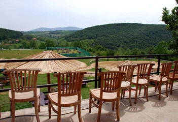 Fototapeta premium Wooden chairs on mountain terrace