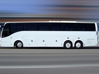 white tour bus in motion