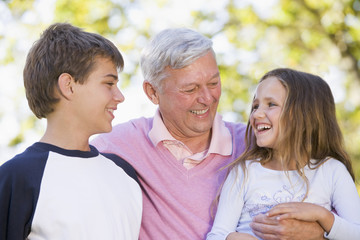 Grandfather laughing with grandchildren