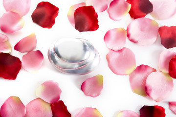 pile of round pebbles with rose petals