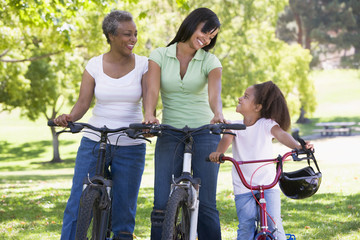 Obraz premium Grandmother mother and granddaughter bike riding
