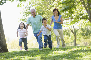 Grandparents running with grandchildren - obrazy, fototapety, plakaty