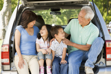 Grandparents with grandkids in tailgate of car