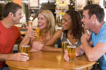 Group of young friends drinking and laughing in a bar - Powered by Adobe