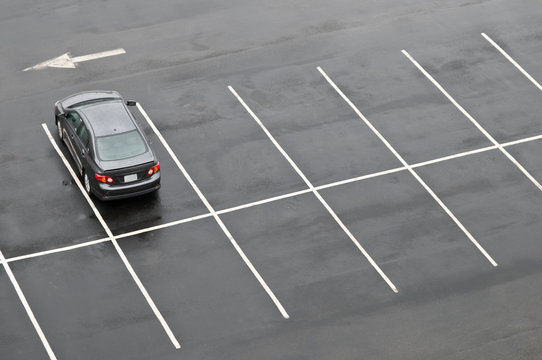 Single car in empty parking lot