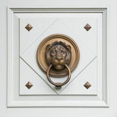 lionhead knocker found on a door of a classical hungarian palace