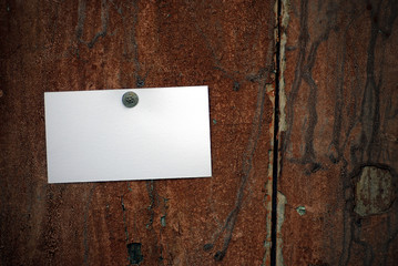 business card fixed on a door with a thumbtack