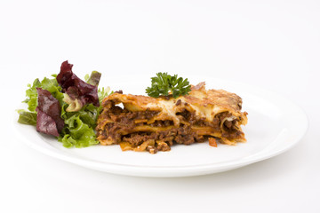 piece of lasagna al forno with some salad