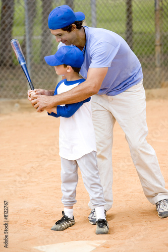 Young Boy Being Taught How To Swing A Baseball Bat Stock Photo And Royalty free Images On