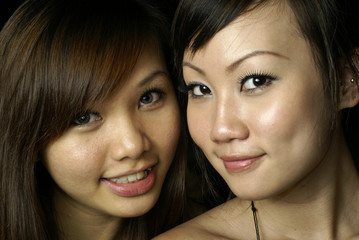 Two happy asian lady friends