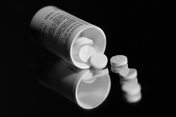 Open Container With Spilled Pills