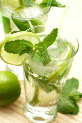 Two mojito cocktails on wooden background