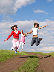 Fototapeta na wymiar Three jumping girls