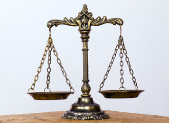 A photo of the scales of justice with a balance theme overlay