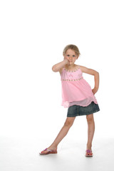 cute girl standing with hip pushed out and elbows bent.