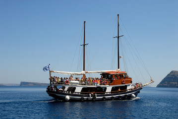 Traditional sailing boat with tourists in Santorini, Greece