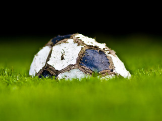 old soccer ball on grass