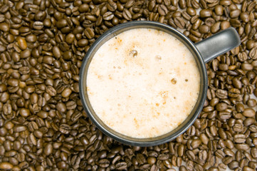 Cup with coffee, costing on coffee grain