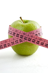 Green apple and tape measure