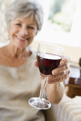 Woman in living room with glass of wine