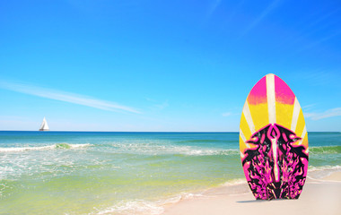 Pink and Yellow Surf board at beach
