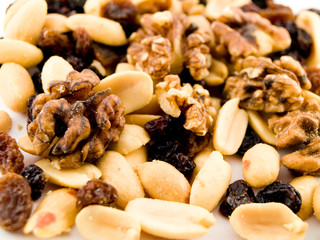 Close Up Walnuts Peanuts and Dried Fruit on White Background