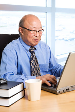 Working Senior Asian Businessman