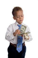 Young boy dressed as businessman holds money - isolated on white