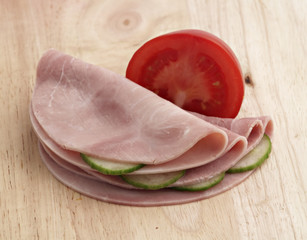 ham with vegetables on wooden board