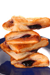 Stack of blueberry turnovers on a blue plate