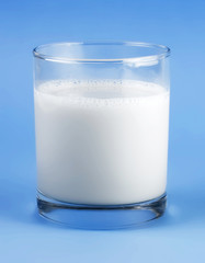 Glass of milk isolated on blue background