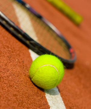 A tennis ball with rackets on the background.jpg
