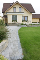 Yellow hous and summer garden.